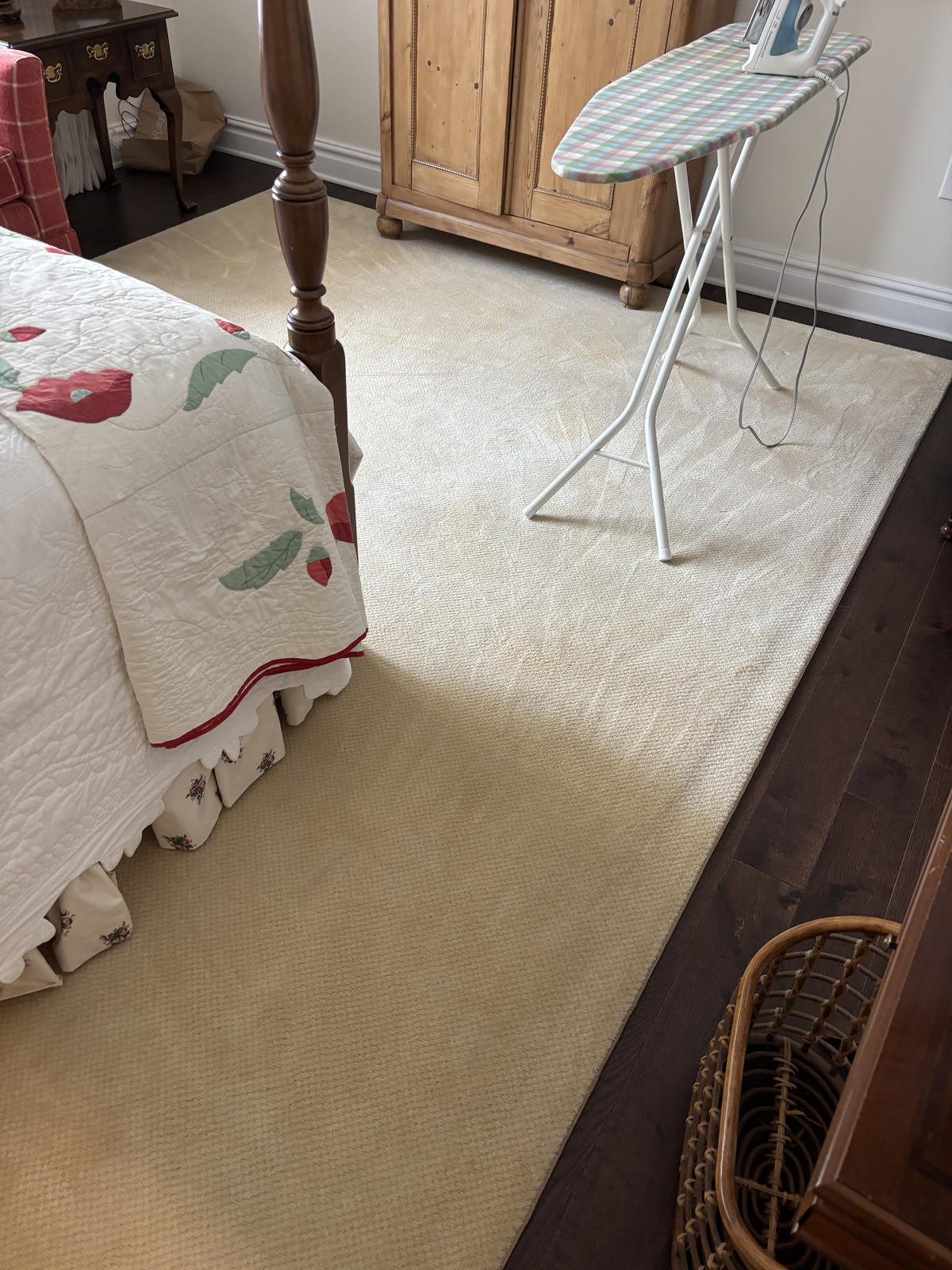 Extraction wand cleaning fabric beside a tidy bedroom