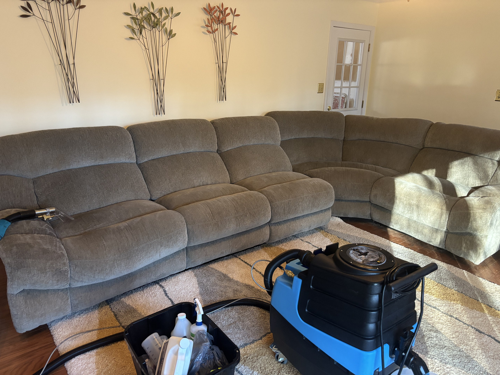 Double Deep Clean deep-cleaning a large fabric sectional with professional hot-water extraction equipment