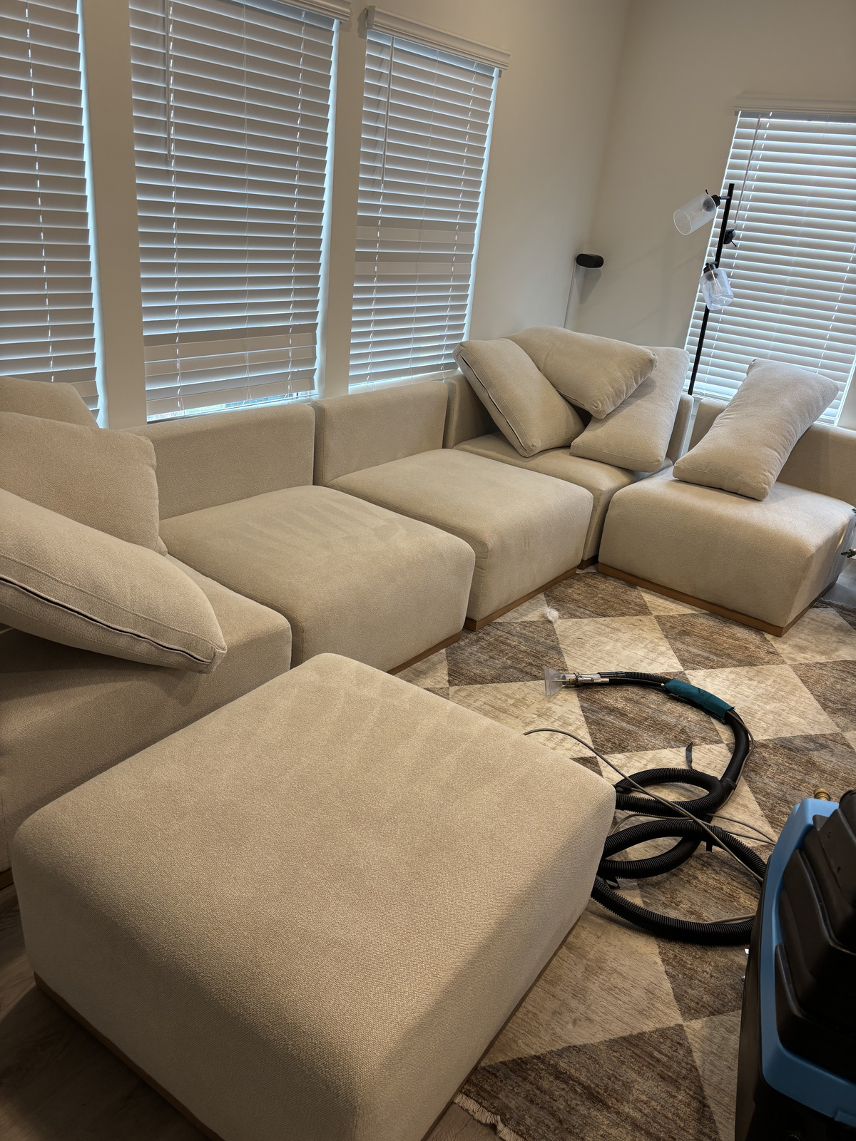 Sectional sofa mid-clean with Double Deep Clean's extraction machine running